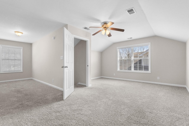 additional living space with visible vents, carpet floors, and lofted ceiling