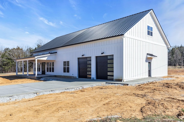 exterior space with concrete driveway and a garage