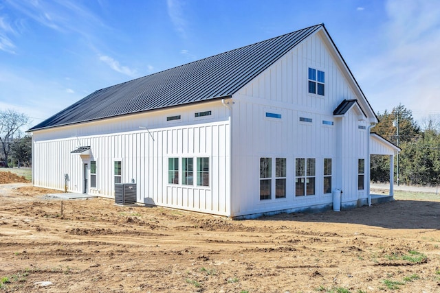 back of property featuring metal roof, board and batten siding, and a standing seam roof