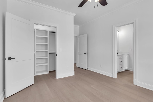 unfurnished bedroom with light wood-style flooring, connected bathroom, baseboards, and ornamental molding