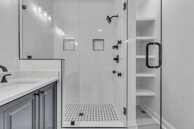 bathroom featuring a stall shower and vanity