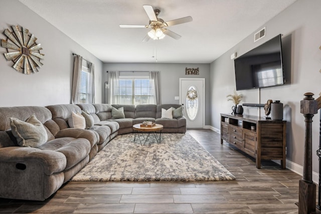 living area with wood finish floors, visible vents, baseboards, and a ceiling fan