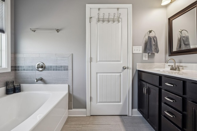 full bath with a bath and vanity