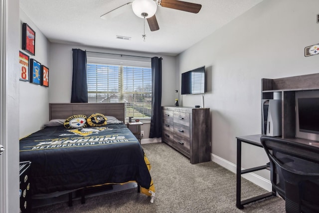 bedroom featuring visible vents, baseboards, light carpet, a textured ceiling, and a ceiling fan