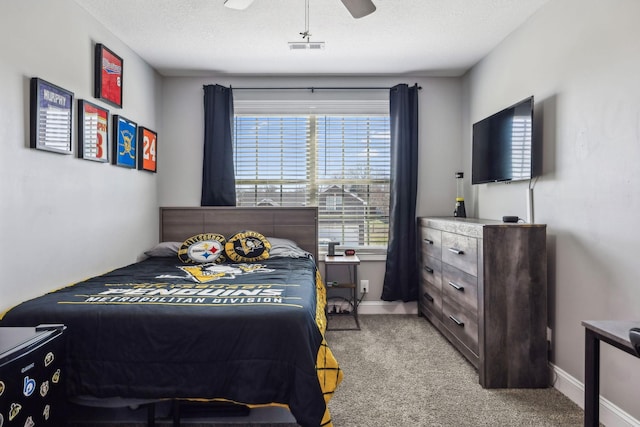 bedroom featuring visible vents, light carpet, baseboards, and a ceiling fan