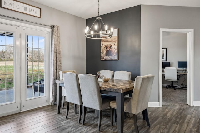 dining space with dark wood finished floors, plenty of natural light, and a chandelier