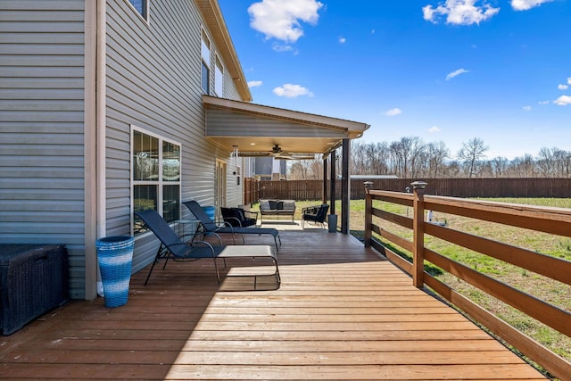 deck with an outdoor living space, ceiling fan, and fence