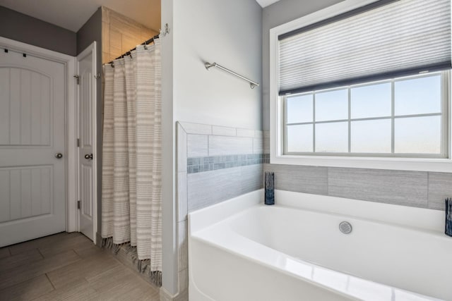 bathroom with a garden tub