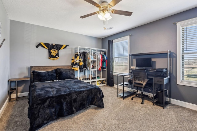 bedroom with carpet flooring, ceiling fan, baseboards, and visible vents