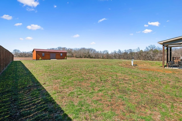 view of yard with an outbuilding and fence