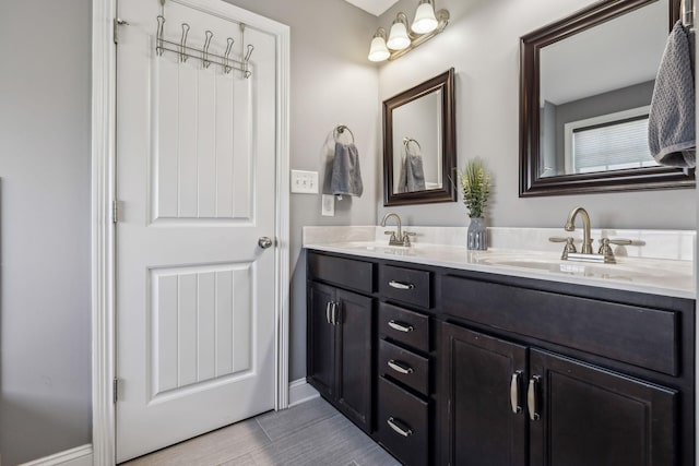 full bathroom with a sink and double vanity