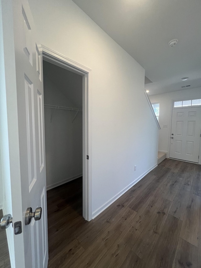 entrance foyer with dark wood finished floors and baseboards