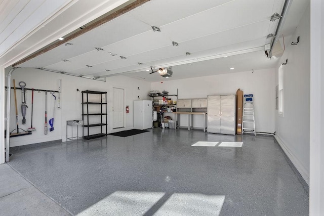 garage featuring baseboards and a garage door opener