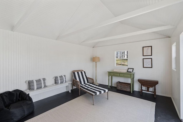 sitting room with vaulted ceiling with beams and baseboards