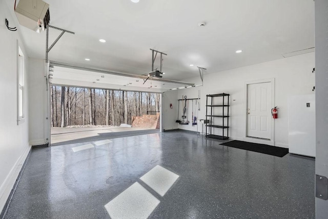 garage featuring recessed lighting, a garage door opener, and baseboards