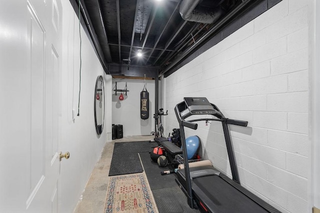 workout area with concrete block wall