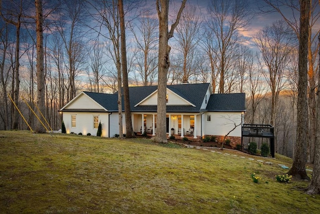 view of front of property with a yard and a porch