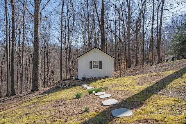 view of outbuilding with a view of trees and an outdoor structure