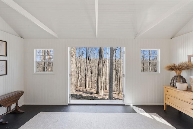 interior space featuring multiple windows, baseboards, and lofted ceiling