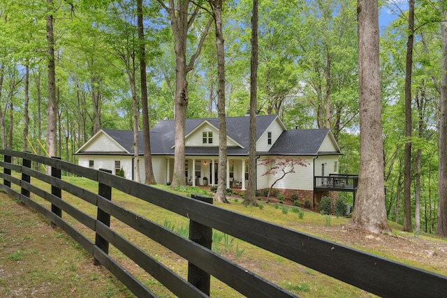 back of house with fence and covered porch