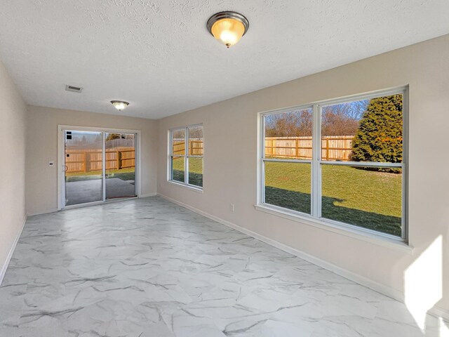 1036 Middleton Ln, Gallatin, TN 37066 - empty room featuring visible vents, baseboards, a textured ceiling, and marble finish floor