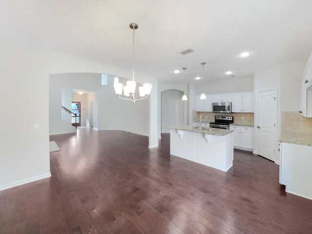 1036 Middleton Ln, Gallatin, TN 37066 - kitchen featuring visible vents, tasteful backsplash, white cabinetry, stainless steel appliances, and arched walkways