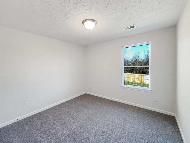 1036 Middleton Ln, Gallatin, TN 37066 - unfurnished room with visible vents, baseboards, a textured ceiling, and dark carpet