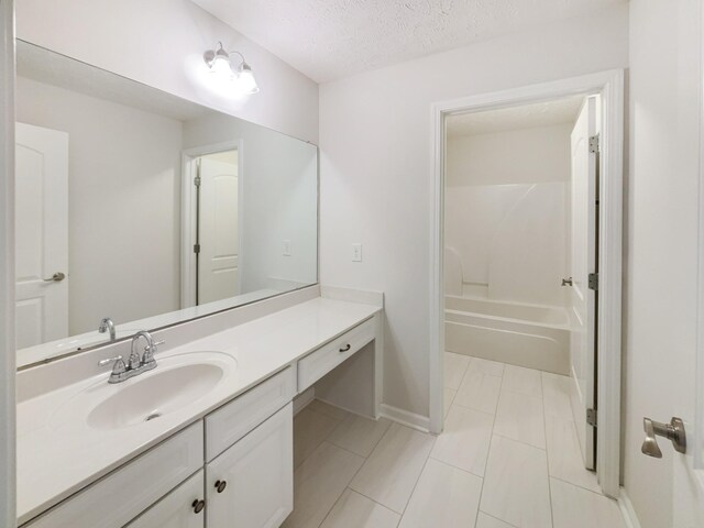 1036 Middleton Ln, Gallatin, TN 37066 - full bath featuring a textured ceiling, vanity, baseboards, and washtub / shower combination