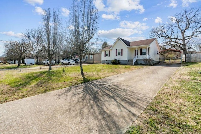 view of front of property with a front yard, fence, driveway, a carport, and crawl space