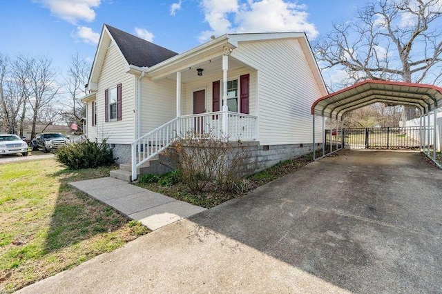 view of front of home with a carport, covered porch, and concrete driveway