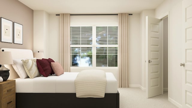 bedroom featuring light colored carpet and baseboards