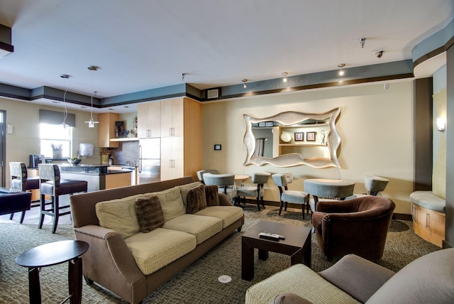 living area featuring baseboards
