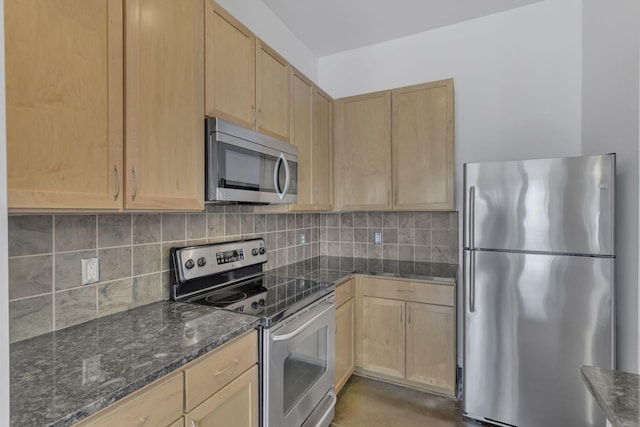 kitchen featuring dark stone counters, backsplash, appliances with stainless steel finishes, and light brown cabinetry