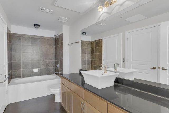 bathroom with vanity, toilet, visible vents, and shower / bathtub combination