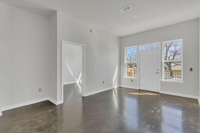 entrance foyer with visible vents, finished concrete flooring, and baseboards