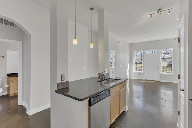 kitchen featuring visible vents, a sink, concrete flooring, arched walkways, and stainless steel dishwasher