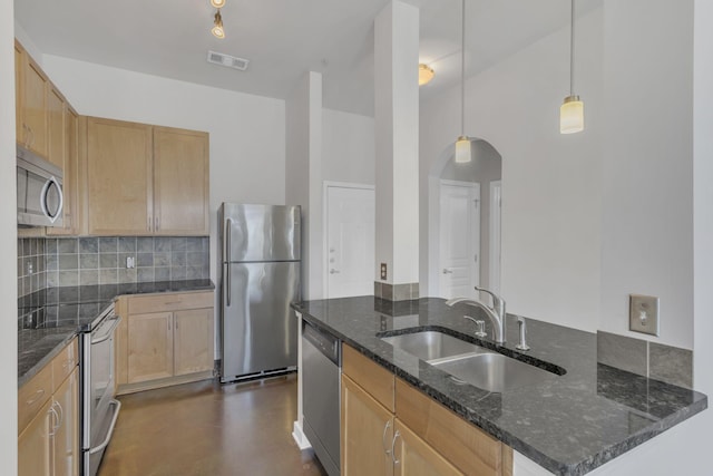 kitchen with tasteful backsplash, visible vents, light brown cabinets, appliances with stainless steel finishes, and a sink