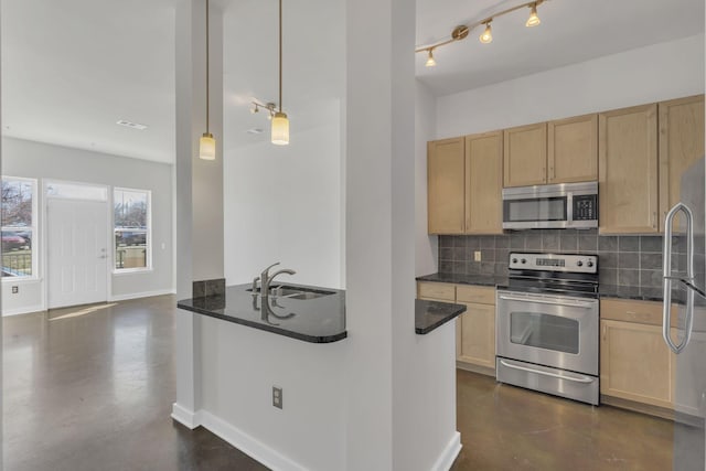 kitchen with finished concrete floors, light brown cabinets, stainless steel appliances, and a sink