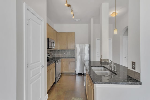 kitchen with visible vents, decorative backsplash, dark stone countertops, appliances with stainless steel finishes, and a sink