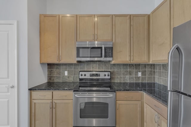 kitchen with dark stone countertops, light brown cabinets, backsplash, and stainless steel appliances