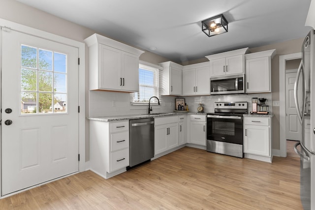 2436 J D Todd Rd, Murfreesboro, TN 37129 - kitchen with backsplash, white cabinetry, stainless steel appliances, and a sink