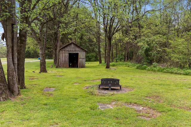 2436 J D Todd Rd, Murfreesboro, TN 37129 - view of yard with a storage shed, an outbuilding, and an outdoor fire pit