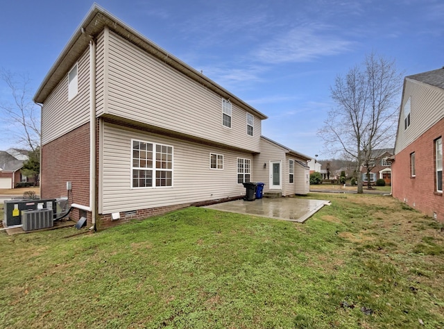 rear view of property with a patio area, central air condition unit, a yard, and crawl space