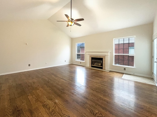 unfurnished living room with wood finished floors, a fireplace, and ceiling fan