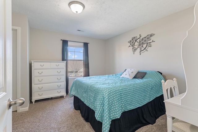 carpeted bedroom with visible vents and a textured ceiling