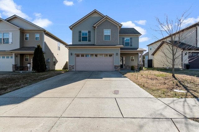 craftsman inspired home with stone siding, driveway, and a garage