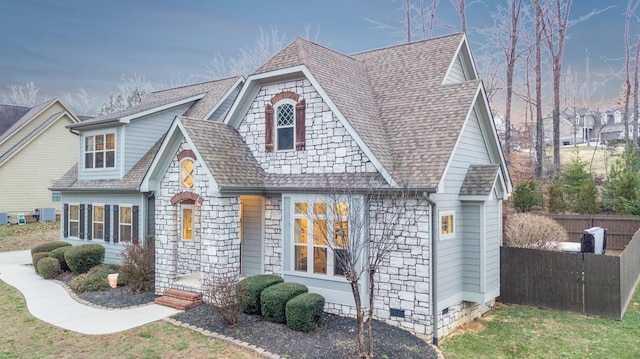 view of front of house with crawl space, central air condition unit, a shingled roof, and a front yard