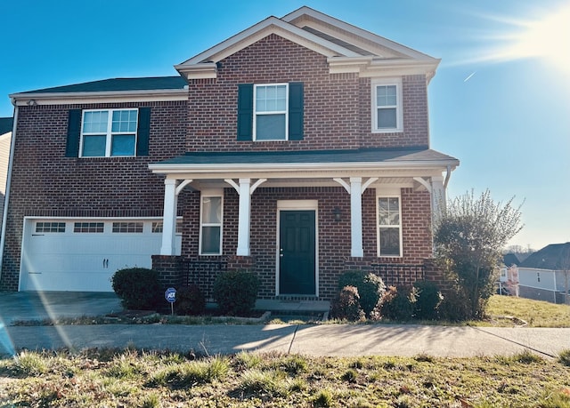 traditional-style home featuring a garage, brick siding, and concrete driveway