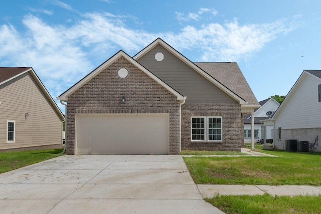 871 Blessings Way, Gallatin, TN 37066 - view of front of house with concrete driveway, a front lawn, a garage, central air condition unit, and brick siding