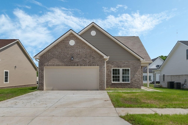 view of front of house with concrete driveway, a front lawn, a garage, central air condition unit, and brick siding